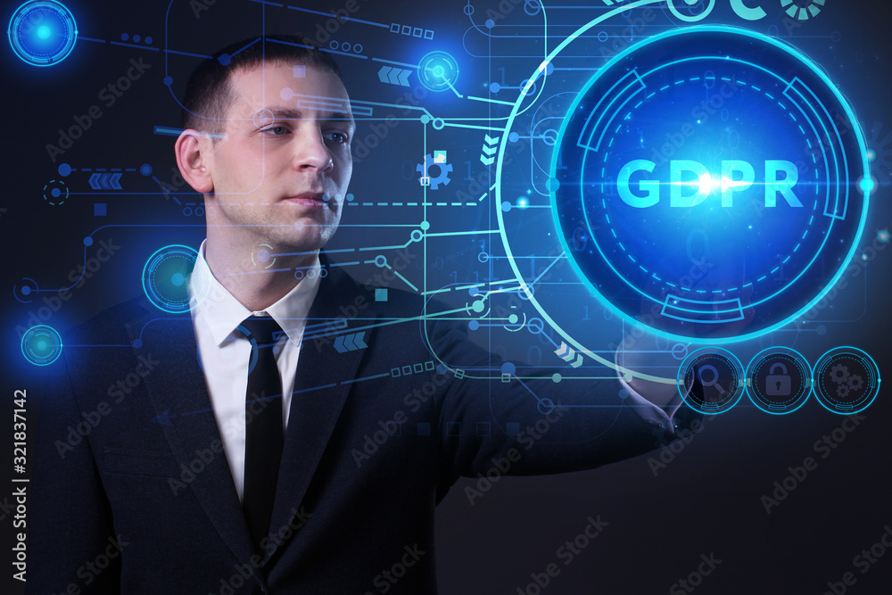 Business, Technology, Internet and network concept. Young businessman working on a virtual screen of the future and sees the inscription: GDPR Business, Technology, Internet and network concept. Young businessman working on a virtual screen of the future and sees the inscription: GDPR