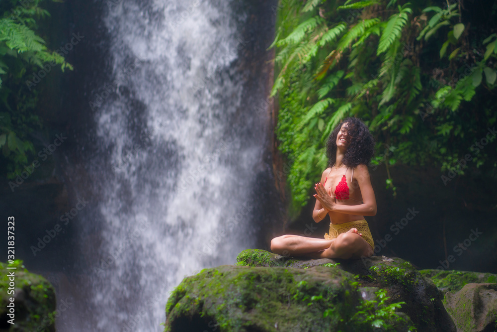 outdoors portrait of young attractive and happy hipster girl doing yoga at beautiful tropical waterfall meditating enjoying freedom and¡ nature in wellness and zen lifestyle outdoors portrait of young attractive and happy hipster girl doing yoga at beautiful tropical waterfall meditating enjoying freedom and¡ nature in wellness and zen lifestyle