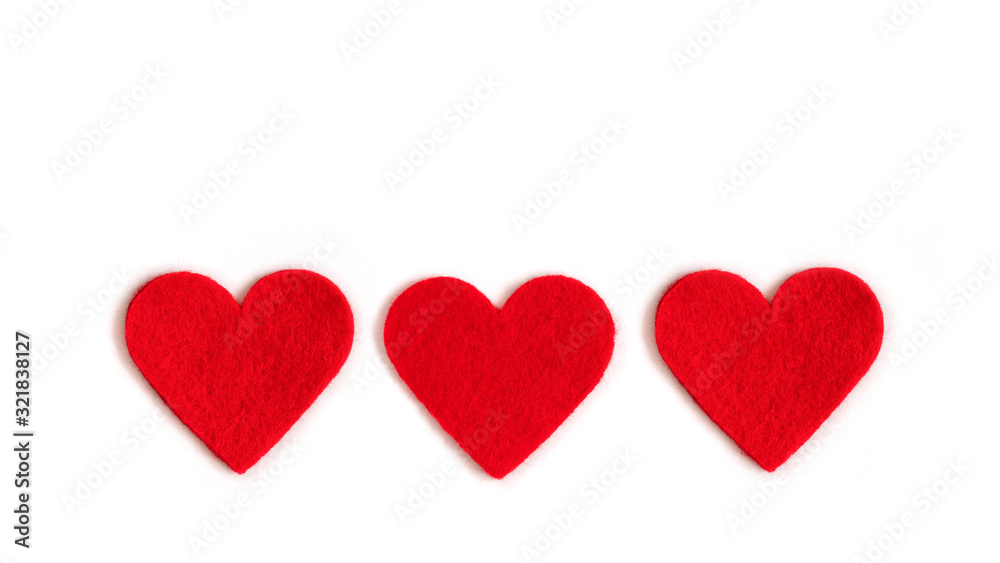 Red textile hearts on a white background. Valentines day or mothers day background. Copy space, top view.