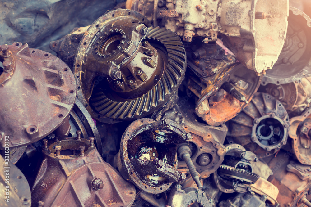 Old Machine parts in warehouses. Car parts in old warehouses. Used vehicle part for recycling in the scrap yard garage. Recycle goods/meta.