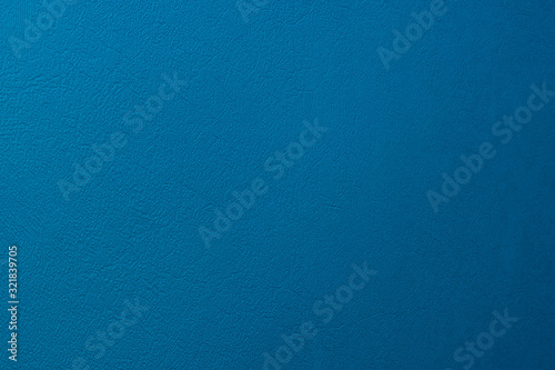 Textured background of matte wall of blue colour