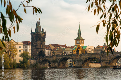 View of the Charles Bridge Through Autumn Leaves in Prague, Czechia