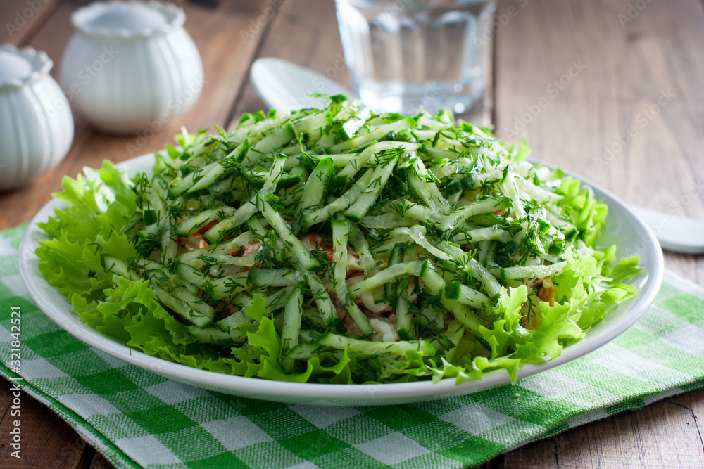 Norwegian salad salad of canned fish and fresh cucumber, selective focus Norwegian salad salad of canned fish and fresh cucumber, selective focus