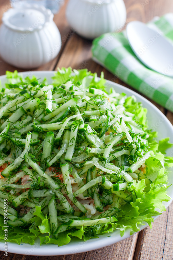 Norwegian salad salad of canned fish and fresh cucumber, selective focus Norwegian salad salad of canned fish and fresh cucumber, selective focus