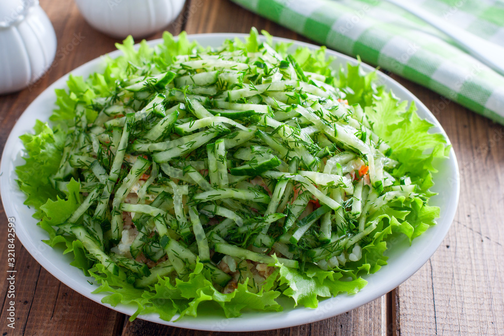 Norwegian salad salad of canned fish and fresh cucumber, selective focus Norwegian salad salad of canned fish and fresh cucumber, selective focus