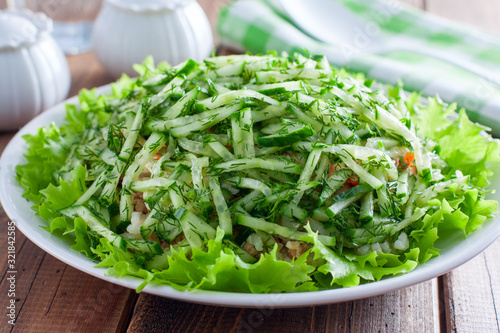 Norwegian salad salad of canned fish and fresh cucumber  selective focus