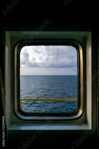 Looking out of window from a cabin of a construction work barge at oil field © wanfahmy