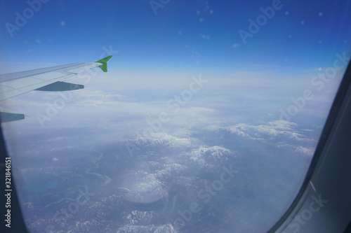 VIew of snow capped mountains from an airplane window