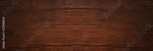 Seamless dark brown wooden board texture background with vignette