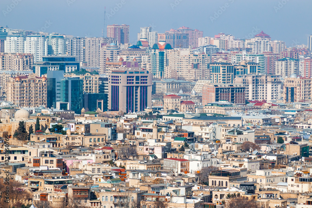 Panorama of Baku, the capital of the Republic of Azerbaijan from a high point of the city. In the center of the city are old historical houses against the background of modern high-rise buildings.