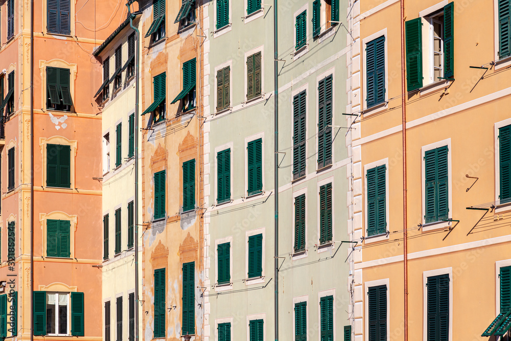 Group of palaces facades of Camogli, painted with famous pastel colors. Camogli is a small fisherman village on the shores of the Ligurian Sea. (Northern Italy).