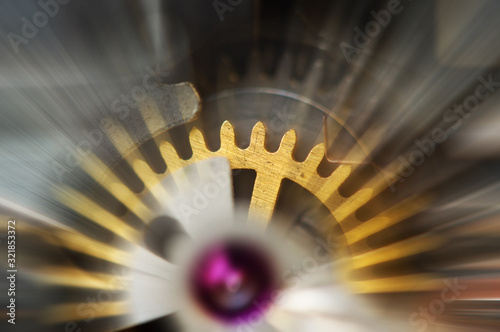 Metal Cogwheels in mechanism , abstract sun beams, Concept Movement is life, Teamwork , Idea Technology, Infinity, Time. Macro photo