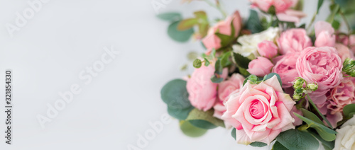Fototapeta Naklejka Na Ścianę i Meble -  Beautiful rose flowers on a light background. Floral frame in soft colors with white space for text. Art flower background for greeting card for Mother's Day and Valentine's day
