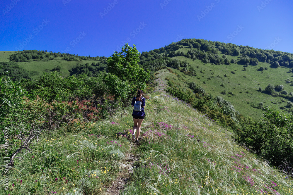 The girl climbs the ridge. Spring Gelendzhik.
