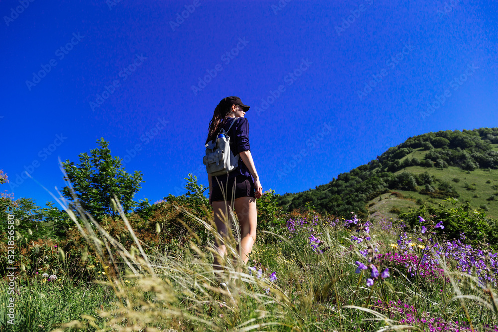 Naklejka premium The girl enjoys being alone in nature. Spring Gelendzhik.