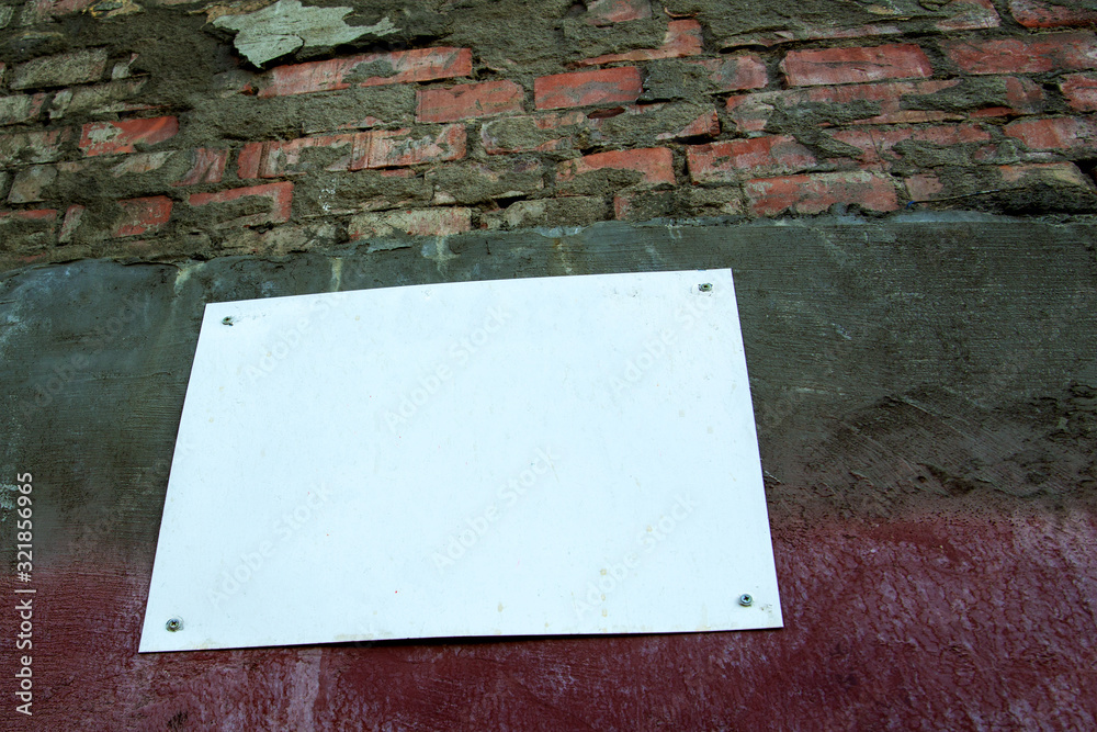 Urban Concrete Brick Wall With Painted Blank Banner Background. Brick wall Texture With Empty Surface For Text Or Image. Outdoor Building Wall With Copy Space
