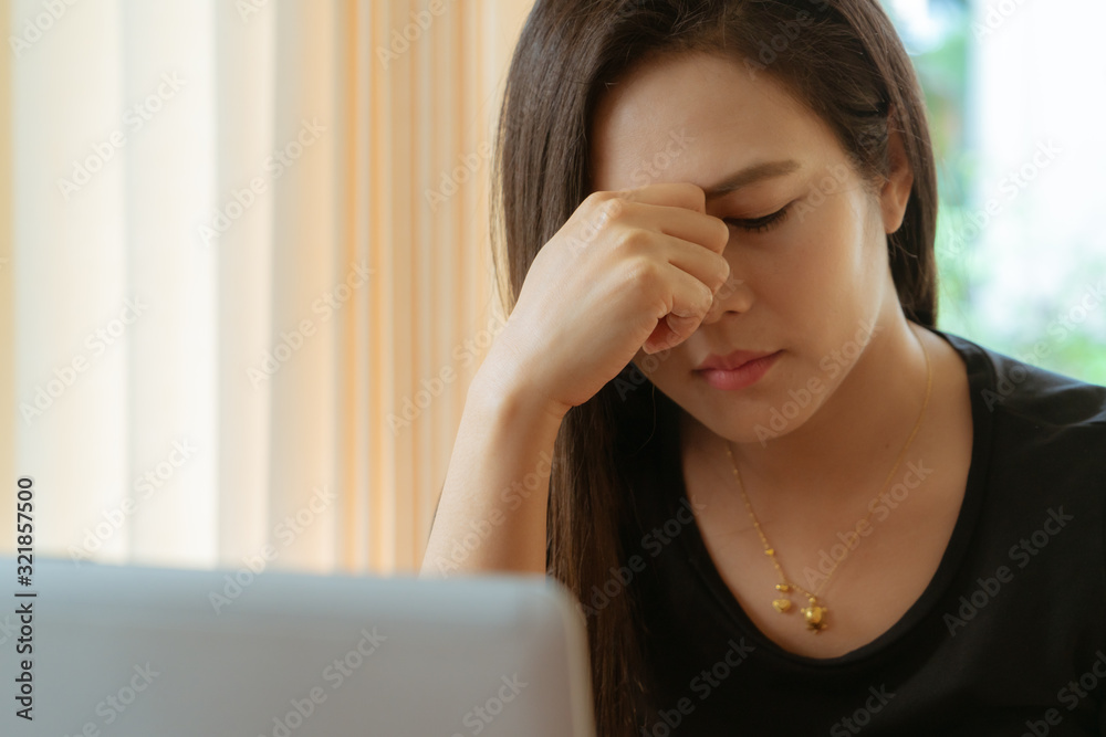 Stressed tired female worker headache, taking break from work. Woman sitting with eyes closed, trying to relieve pain and calm down at workplace