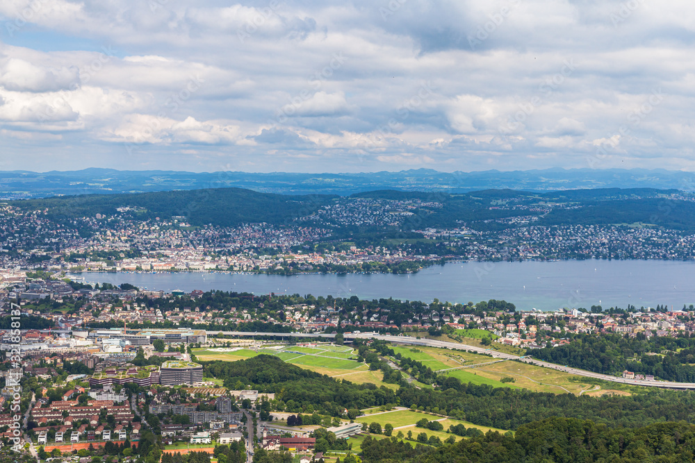 Aerial panorama view of Zurich cityscape skyline and Zurich lake from top of Uetliberg mountain on a cloudy summer day with beautifil cloudscape in sky, Switzerland