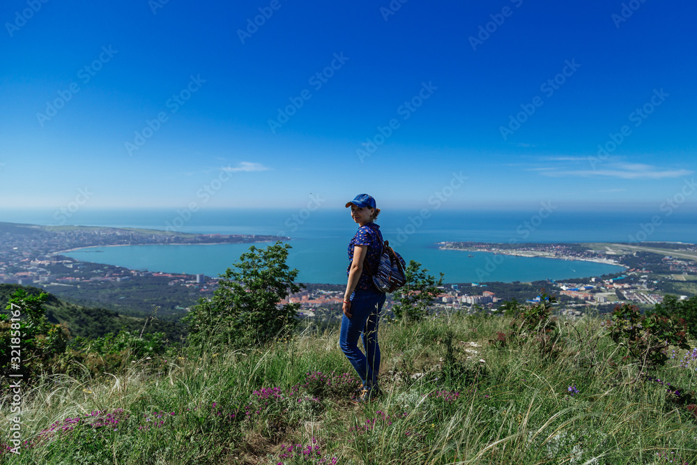 The girl enjoys being alone in nature. Spring Gelendzhik.