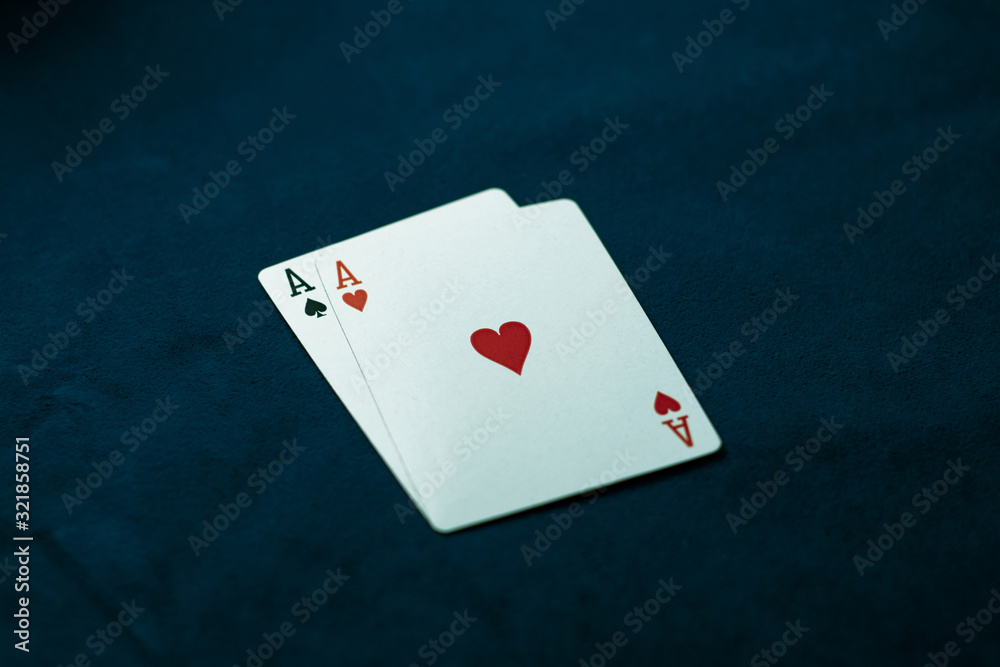 Two aces on a dark table. Ace of Spades and Ace of Hearts. Casino concept Two aces on a dark table. Ace of Spades and Ace of Hearts. Casino concept
