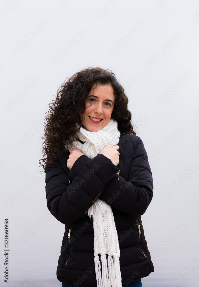 young pretty woman feeling in love, smiling, cuddling and hugging self, staying single, being selfish and egocentric against white wall young pretty woman feeling in love, smiling, cuddling and hugging self, staying single, being selfish and egocentric against white wall