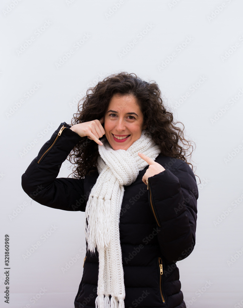 Young and happy pretty woman doing call me sign, curly hair Young and happy pretty woman doing call me sign, curly hair