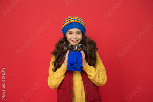 Fashion shop. Cheerful smiling child long hair in stylish outfit. Winter wardrobe. Winter fashion. Hipster fashion trend. Happy winter holidays activity. Feeling warm and happy. Comfy style