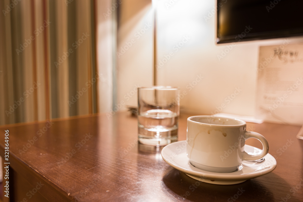 Hotel room water and coffee on a wooden table. Hotel room water and coffee on a wooden table.