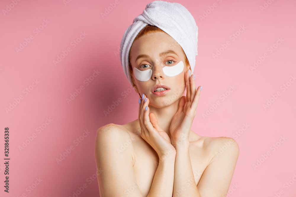 Young woman with patches under eyes isolated on pink background Young woman with patches under eyes isolated on pink background