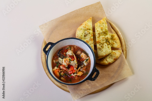 Seafood suop with bread photo