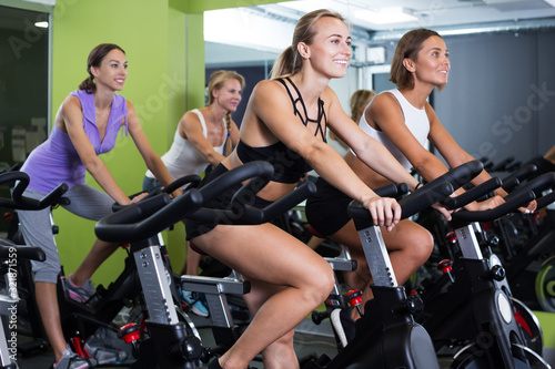 Women cycling in fitness center