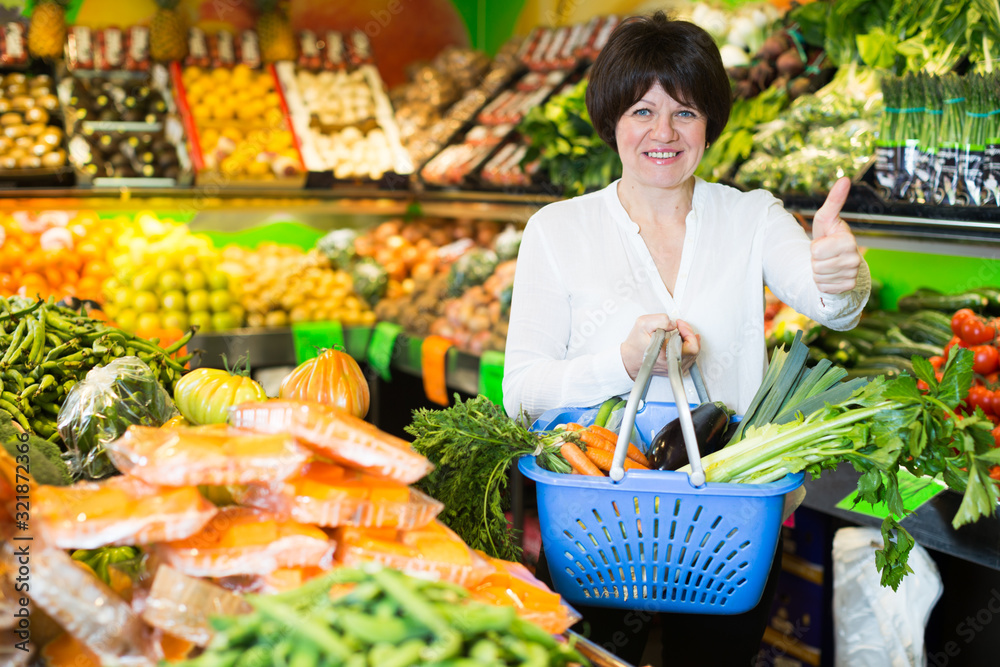 Adult female taking vegetables with basket