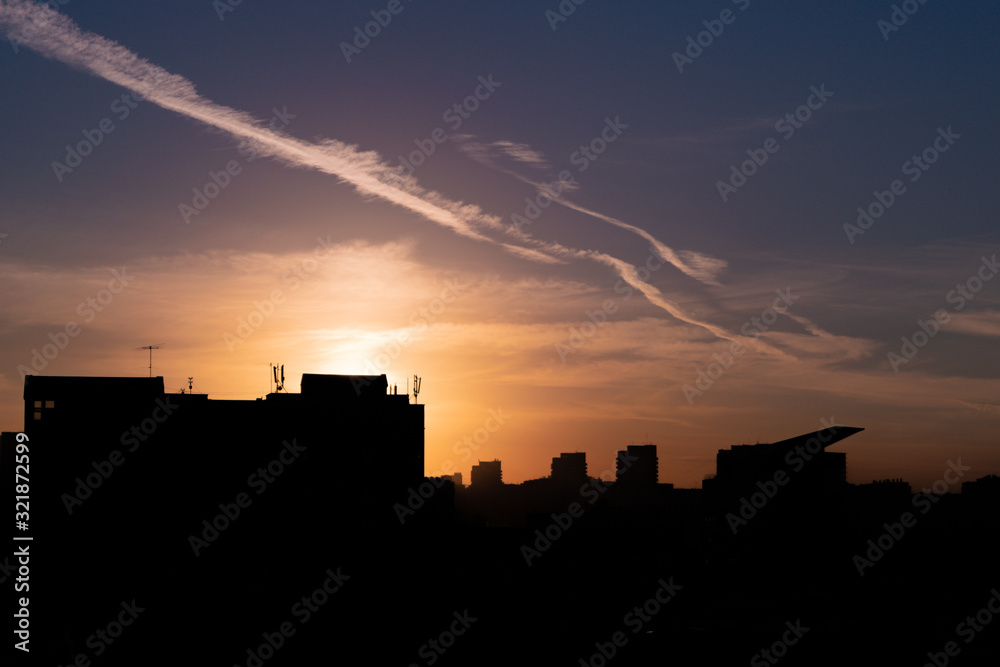 Roof silhouettes against sunset, summer, city