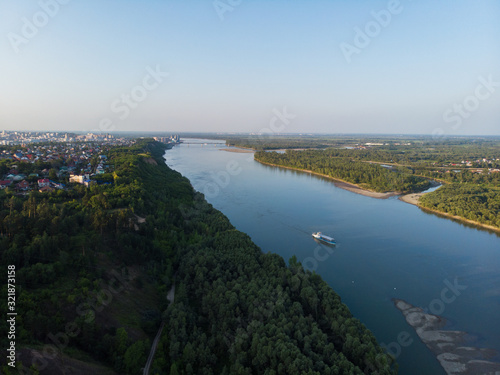 Aerial view of big siberian Ob river and ship, summer day, drone shot