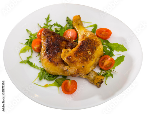 Fried chicken legs with arugula and tomatoes