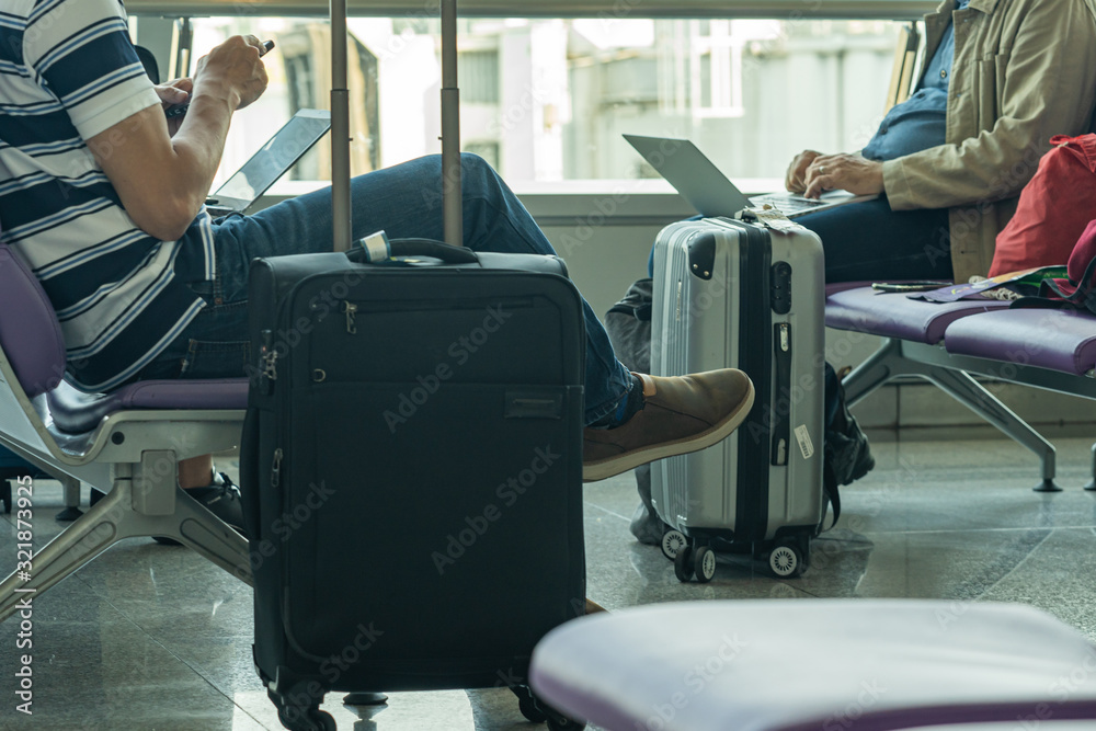 Business people using laptop at departure waiting lounge at airport Business people using laptop at departure waiting lounge at airport