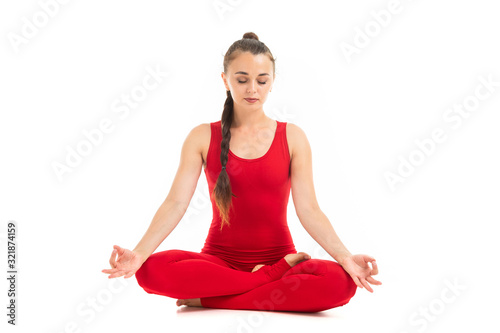 Healthy woman in red t-short and leggins is relaxed and meditating