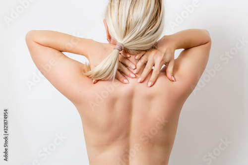 Photography Rear view of a young woman touching her back