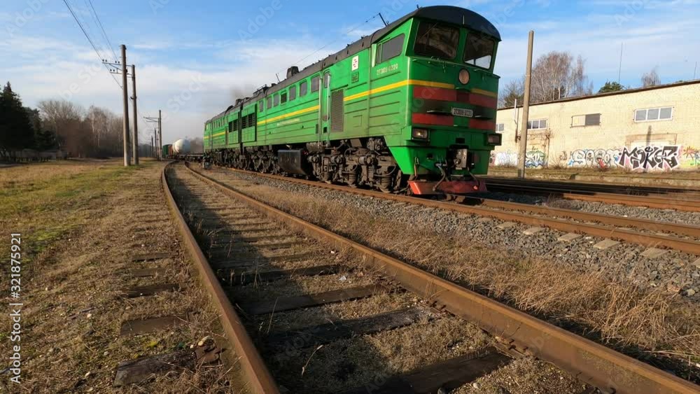 City Riga, Latvia. An old locomotive pulls cargo fast on a sunny day. City Riga, Latvia. An old locomotive pulls cargo fast on a sunny day.