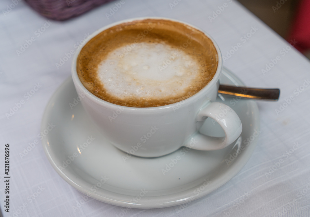 cappuccino coffee cup on the white table cappuccino coffee cup on the white table