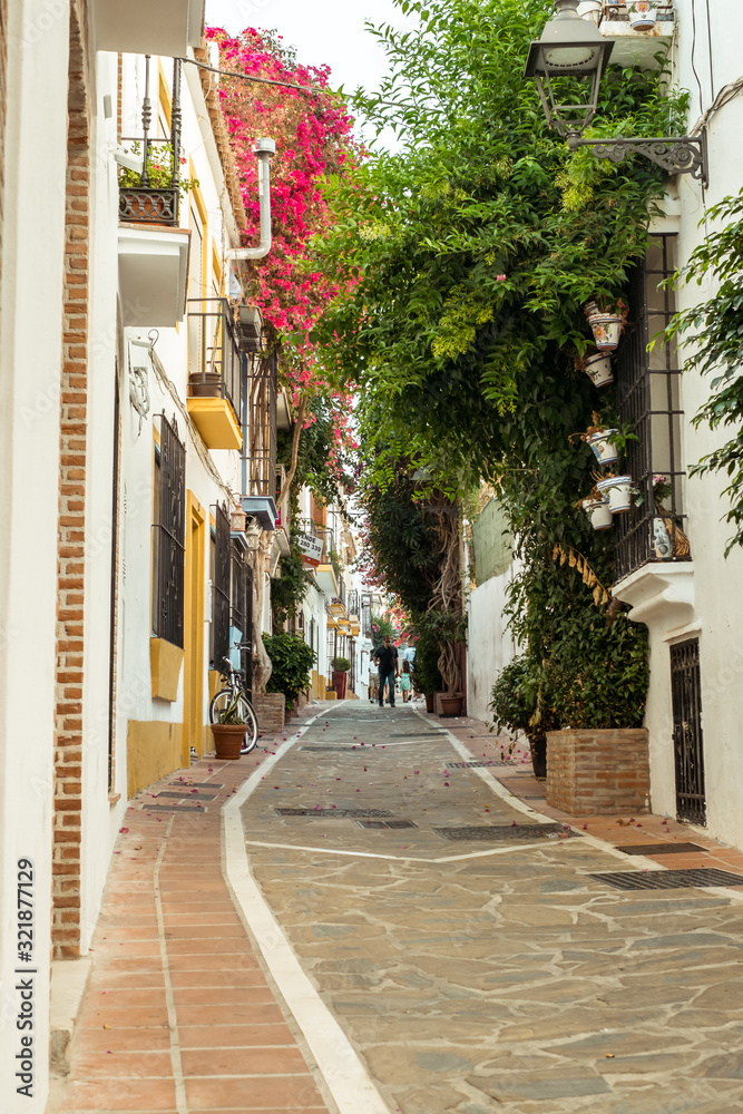 Marbella, Spain - August 26th, 2018. Typical old town street with Spanish architecture in Marbella, Costa del Sol, Andalusia, Spain, Europe