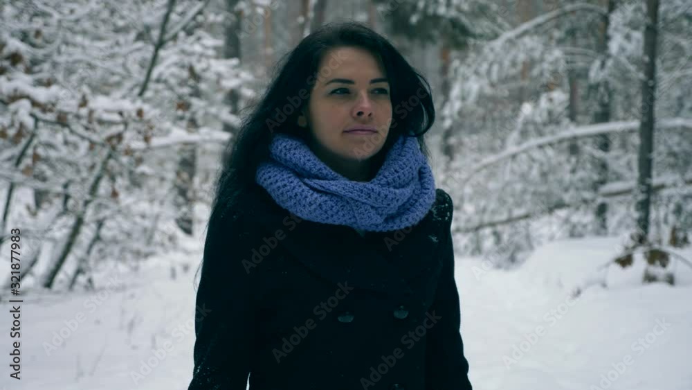Beautiful Girl Walking During Snowfall Blizzard Snow Cyclone In Winter Forest. Frost Weather Snow Covered Trees In Wood. Slow motion Beautiful Girl Walking During Snowfall Blizzard Snow Cyclone In Winter Forest. Frost Weather Snow Covered Trees In Wood. Slow motion