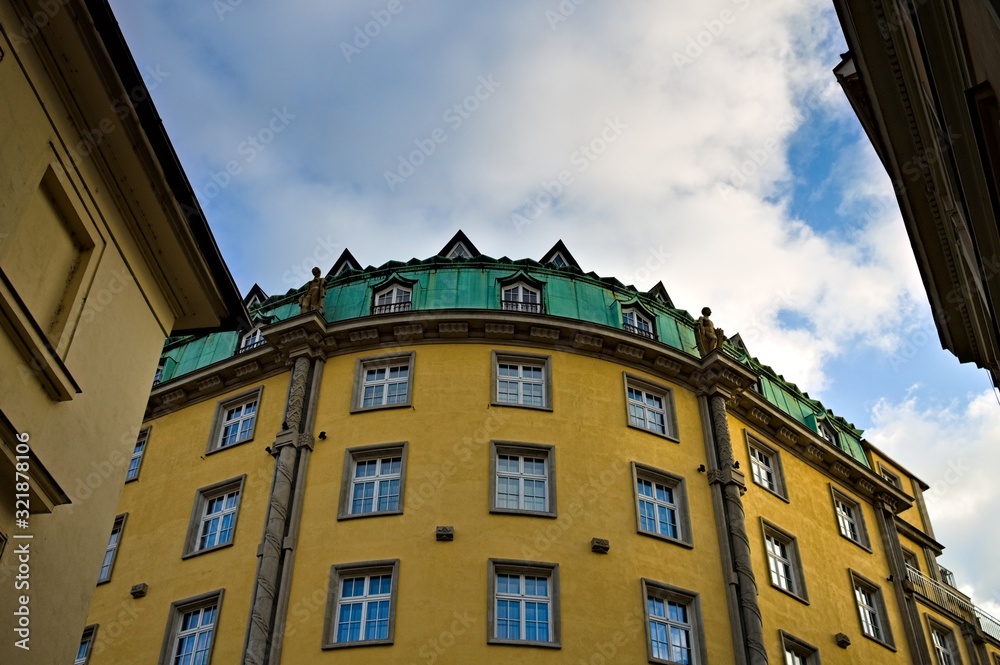 Fototapeta premium A bohemian building with a yellow wall and a green roof (Prague, Czech Republic, Europe)