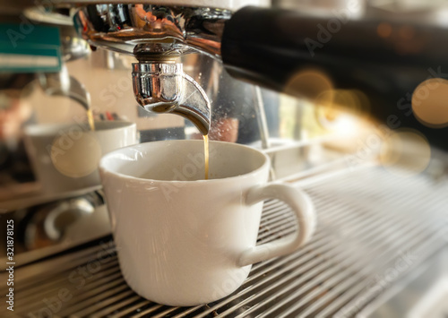 Close-up of espresso pouring from coffee machine by Professional coffee brewing.