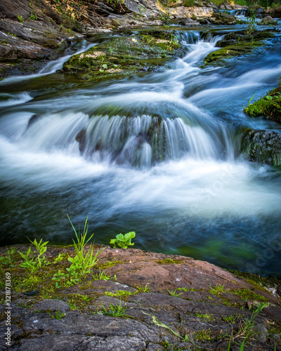 Fototapeta Naklejka Na Ścianę i Meble -  Mountain stream with motion blur, vertical format