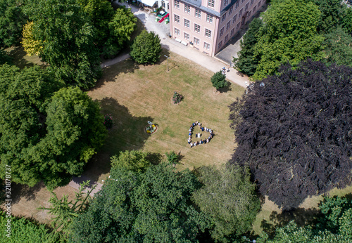 Wedding guests lined up in the shape of heart with bride and groom marriage people photo