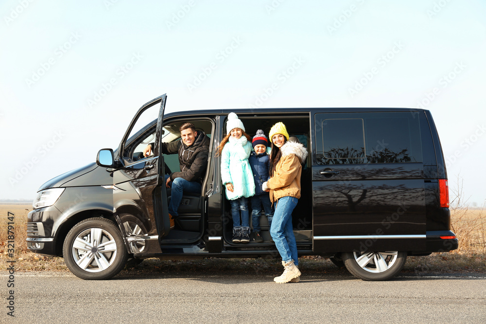 Happy family with little children in modern car on road Happy family with little children in modern car on road