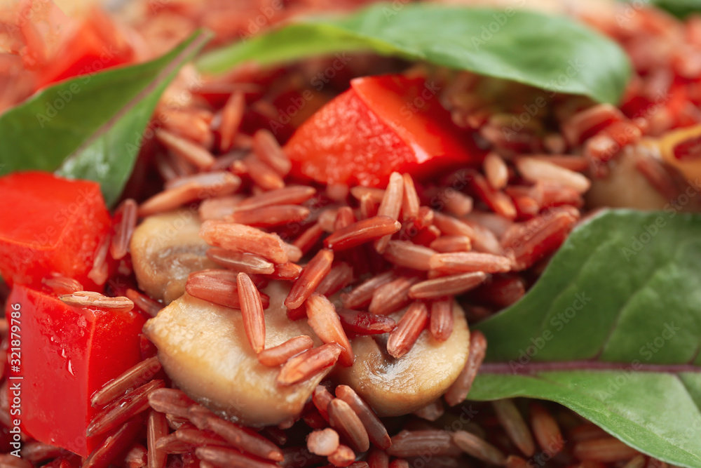 Tasty brown rice with bell pepper and mushroom, closeup Tasty brown rice with bell pepper and mushroom, closeup
