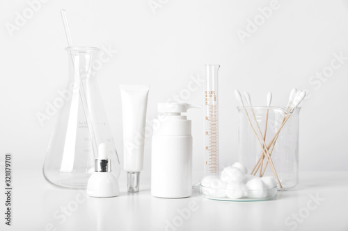 Cosmetic bottle containers and scientific glassware, Blank package for branding mock-up, Pharmaceutical skincare by dermatologist doctor, Research and develop beauty product concept.