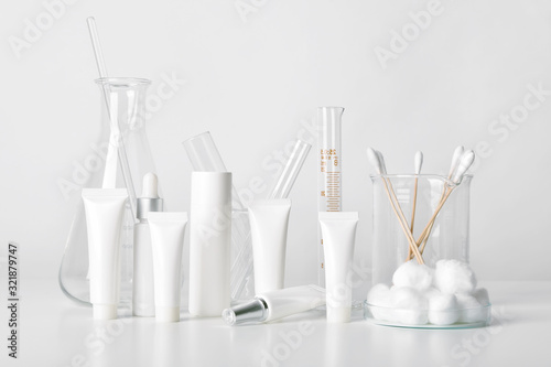 Cosmetic bottle containers and scientific glassware, Blank package for branding mock-up, Pharmaceutical skincare by dermatologist doctor, Research and develop beauty product concept.